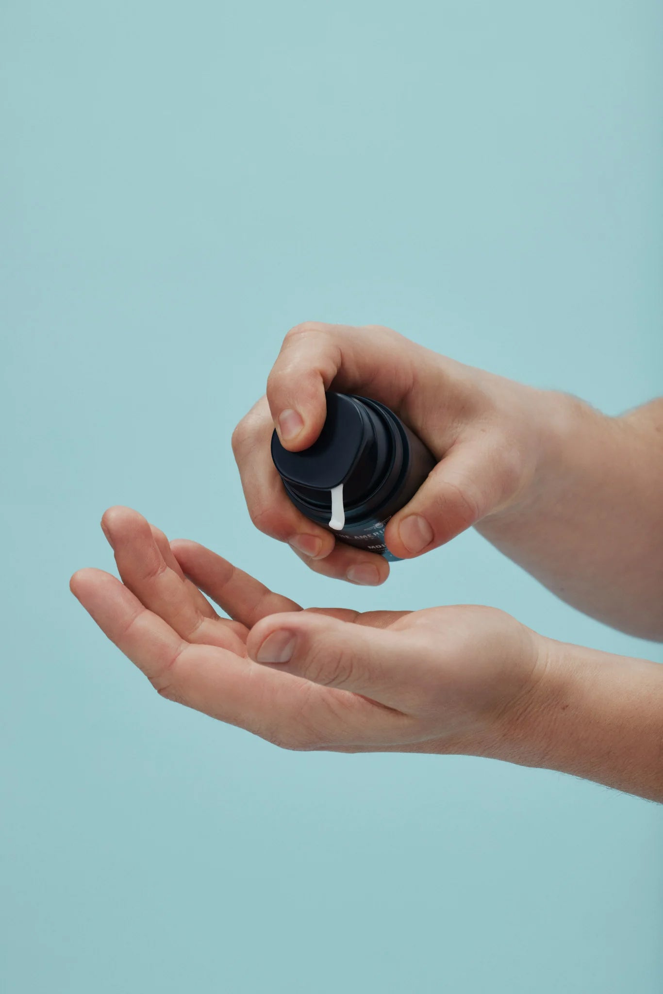 Man applying American Boxer Moisturizer on his hands