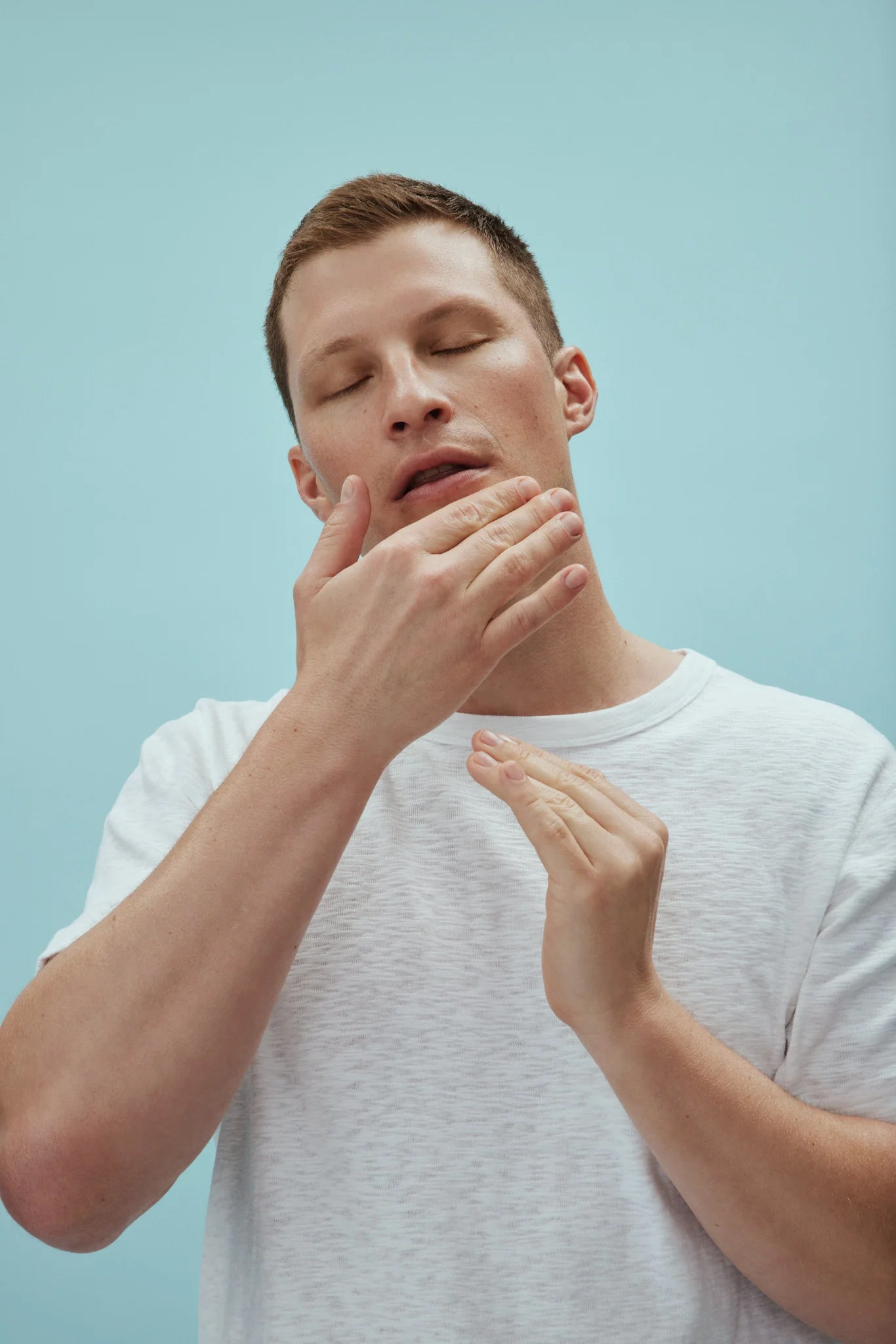 Man applying American Boxer Moisturizer on his face