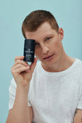 Man holding the American Boxer Moisturizer bottle